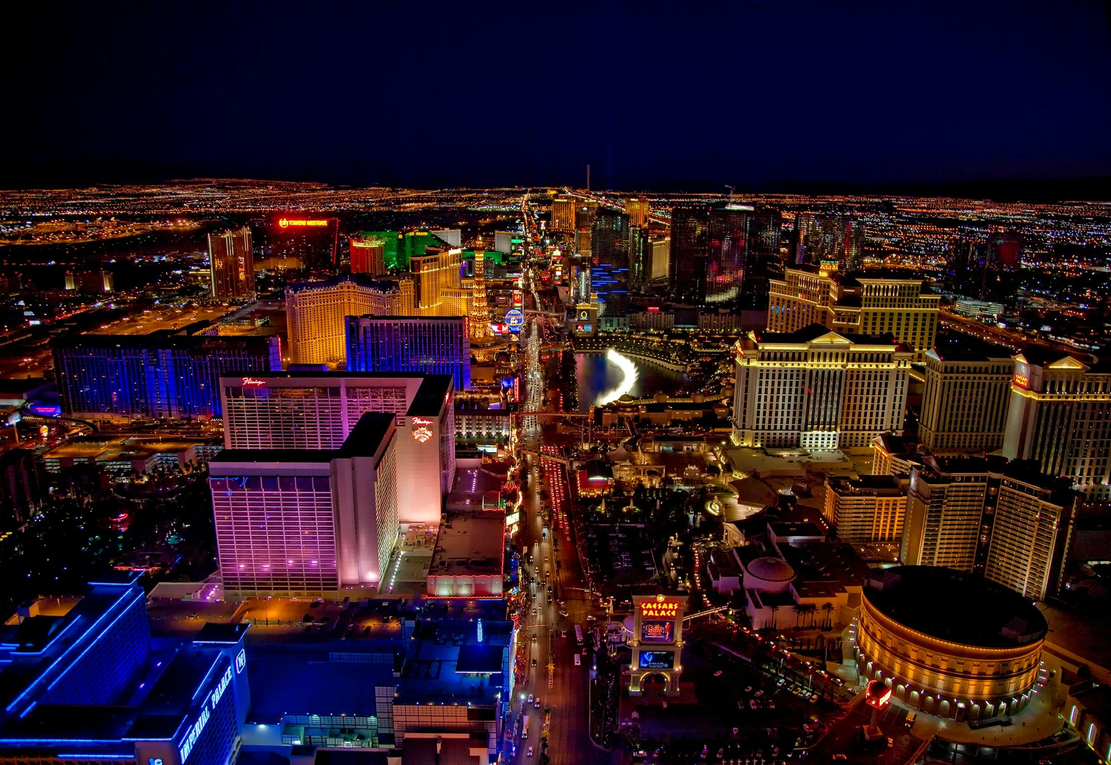 Aerial night view of the Las Vegas Strip with hotels, casinos, and city lights